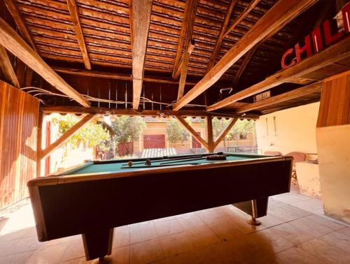a pool table in a room with a ceiling at Countryside house with 3 bedrooms in Secaş