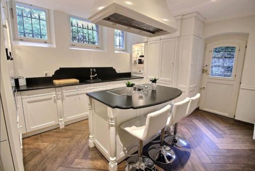 a kitchen with a island in the middle of a room at Villa Kruger on the Lake in Montreux