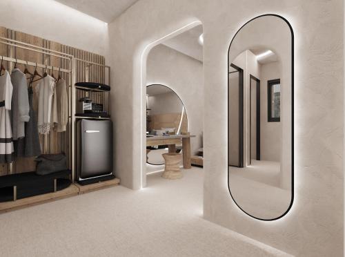 a dressing room with a mirror and a refrigerator at Brilliance of Mykonos in Glastros