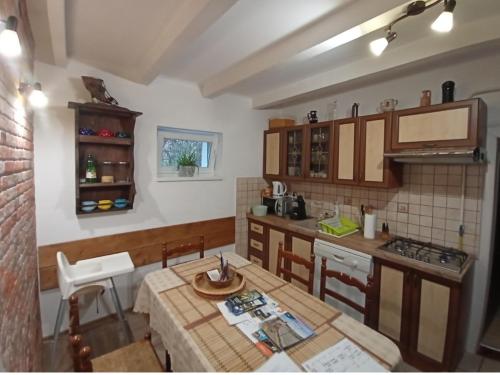 a kitchen with a table and a counter top at Harmónia Parasztház és Apartman in Poroszló