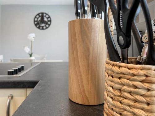 a kitchen counter with a knife holder with utensils at 'Benson View' - 2 bedroom Lake District home in Kendal