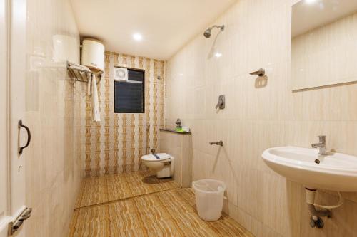 a bathroom with a sink and a toilet at Hotel Comfort Park - Opposite Sri Ramachandra Medical College Porur in Chennai