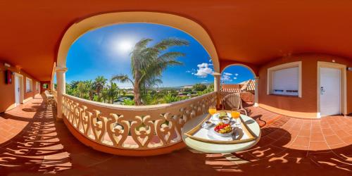 a house with a balcony with a boat on it at Hotel Copacabana Tarifa Beach in Tarifa