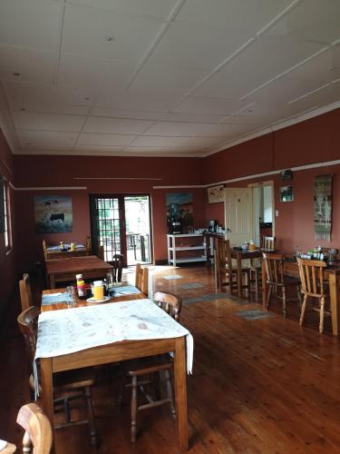 a dining room with a table and some chairs at Rosedale Organic Farm Bed & Breakfast in Addo