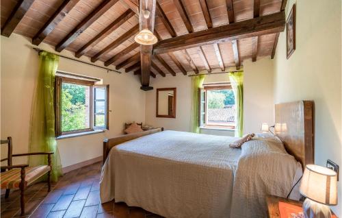 a bedroom with a large bed and two windows at Fico, Oliva, Mora in Calzolaro