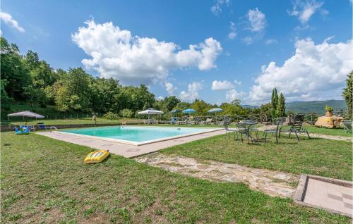 an outdoor swimming pool with chairs and umbrellas at Fico, Oliva, Mora in Calzolaro