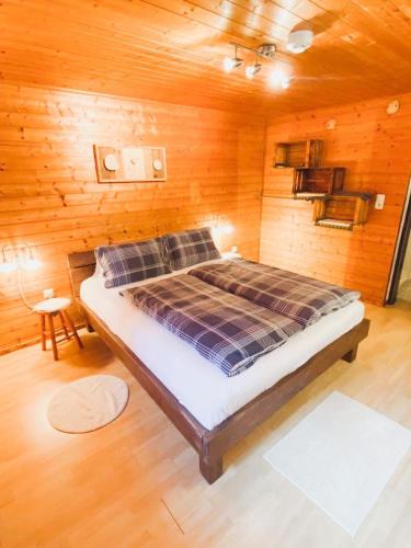 a bedroom with a bed in a wooden room at Ferienwohnung Steinberger in Fügenberg