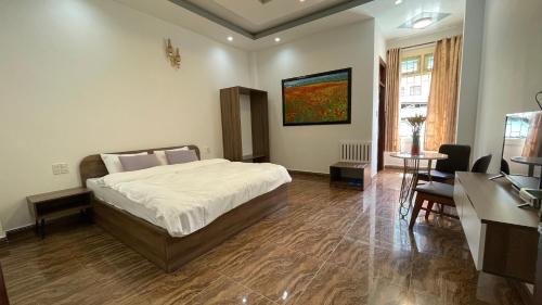 a bedroom with a bed and a table and chairs at Dalat Friendly Fun in Da Lat