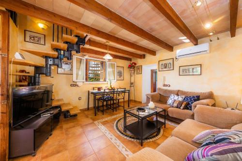 a living room with a couch and a tv at Finca Pep in Sineu