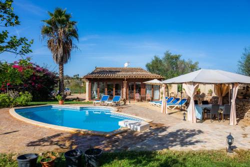 a house with a pool and a gazebo at Finca Pep in Sineu