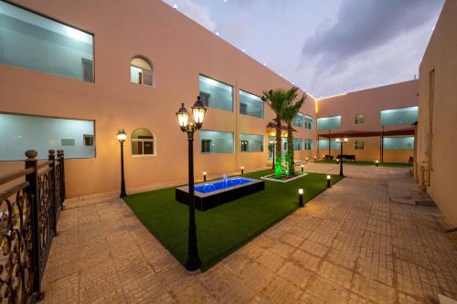a courtyard with a palm tree in a building at شقق قصر الممشى للوحدات السكنية in Jazan