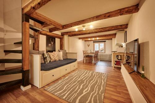 a living room with a bed and a dining room at Lakeside Tiny House Brienz in Brienz