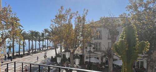 a view of a street with a building and a cactus at Balcon de Europa Suite in Nerja