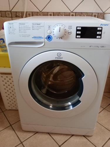 a white washing machine sitting in a kitchen at Summer&Winter Home by the sea in Fiumicino