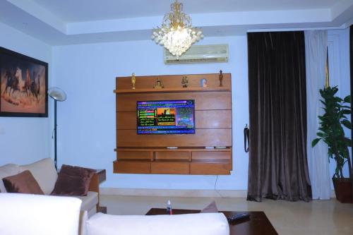 a living room with a tv on a wall at Madinty Stay in Madinaty
