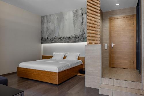 a bedroom with a bed with white sheets at Kievinn in Kyiv