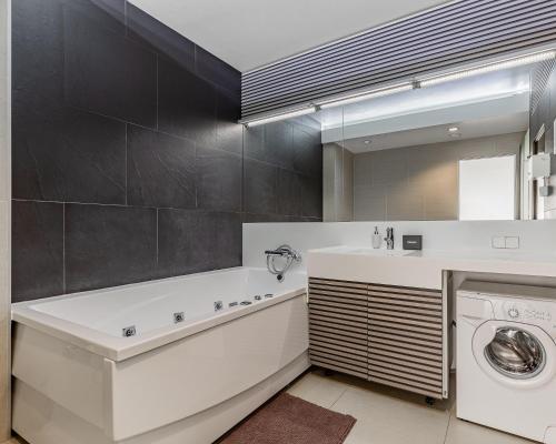 a bathroom with a sink and a washing machine at Kievinn in Kyiv