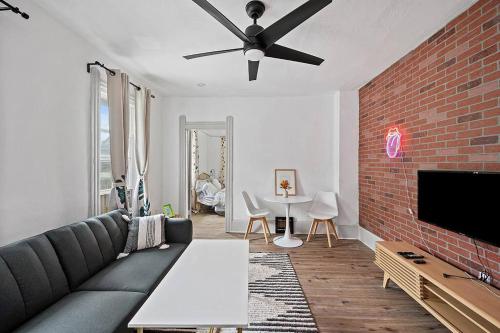 a living room with a couch and a brick wall at Center of Little Italy #4 in Cleveland