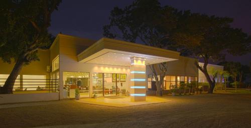 a building with a light pole in front of it at Jade Green Hotel Hambantota in Hambantota