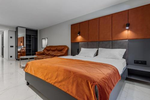 a bedroom with a large bed and a chair at Kievinn in Kyiv