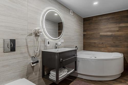 a bathroom with a sink and a toilet and a mirror at Kievinn in Kyiv