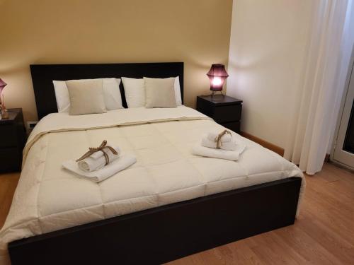 a bedroom with a large bed with two towels on it at La Perla Di Noto in Noto