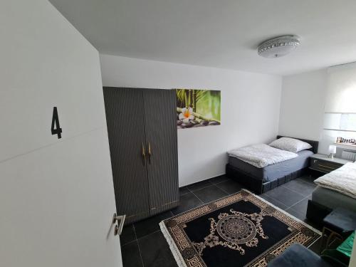 a room with a door and a couch and a rug at Roggendorf Zimmervermietung in Roggendorf