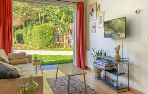 a living room with a couch and a window at Lovely Home In Heinkenszand With Sauna in Heinkensand