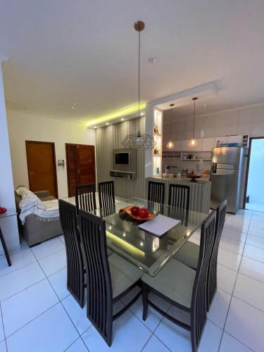 a kitchen and dining room with a table and chairs at Casa Camocim in Camocim