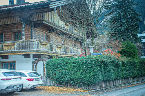 a white car parked in front of a house at EMMA´s Chalet in Mayrhofen