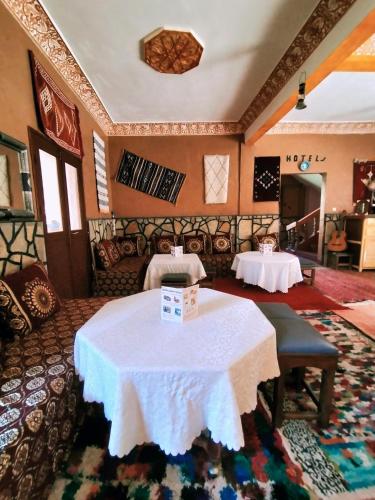 a room with a table with a white table cloth at auberge restaurant tizgui in Tinerhir