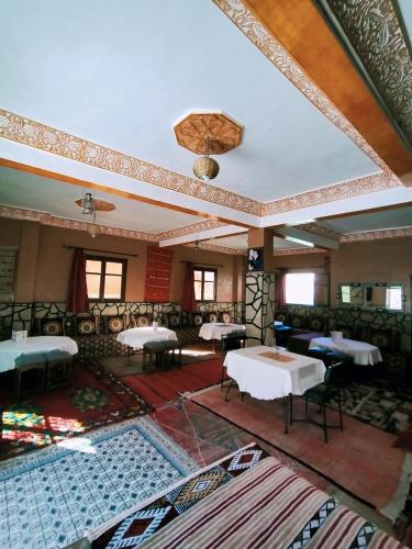 an empty room with tables and a ceiling at auberge restaurant tizgui in Tinerhir