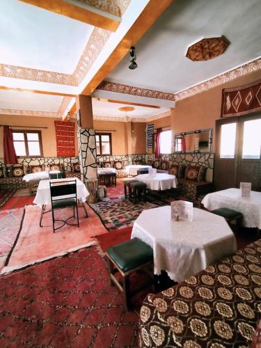 a restaurant with tables and chairs in a room at auberge restaurant tizgui in Tinerhir