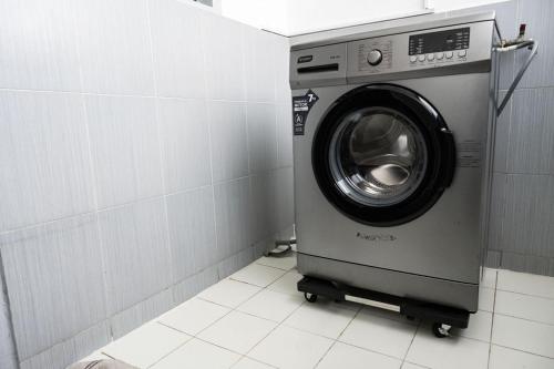a washing machine sitting in a bathroom stall at Sublime appartement à Cocody Riviera Bonoumin . in Abidjan