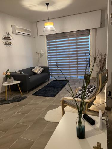 a living room with a couch and a table at Joanna Court rooms in Larnaca