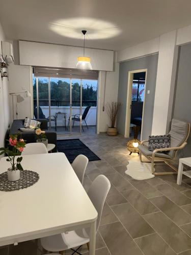 a living room with a white table and chairs at Joanna Court rooms in Larnaca