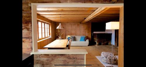a living room with a couch and a table in a room at Alpenlodge Tgèsa Surrein Giassa10 in Sedrun