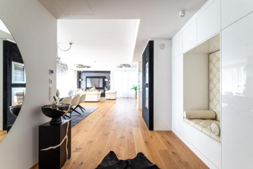a living room with white walls and a wooden floor at Exclusive 2BR Skyline Penthouse by HM in Vienna