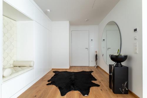 a room with a black rug on the floor at Exclusive 2BR Skyline Penthouse by HM in Vienna