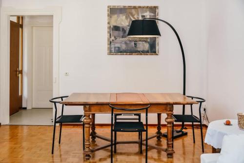 a dining room table with chairs and a lamp at Casa Celio Ambrì in Quinto