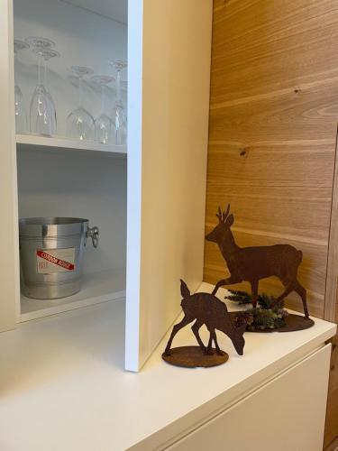 a figurine of a couple of deer on a shelf at Chalet Lilla Livigno in Livigno