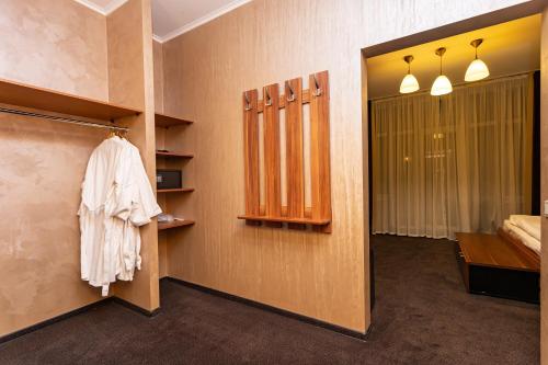 a corridor of a room with a bed and a closet at Perlyna Resort in Cherkasy