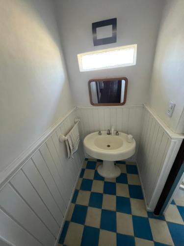 a small bathroom with a sink and a toilet at B&B Cerro Krund in Ushuaia