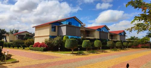 a house on a street with trees and bushes at Bandipur Wildlife Resort & Spa, Bandipur in Bandipūr
