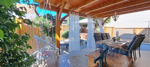 a patio with a table and chairs on a deck at RIVER KOLPA APARTMENT, Griblje ob reki Kolpi in Gradac