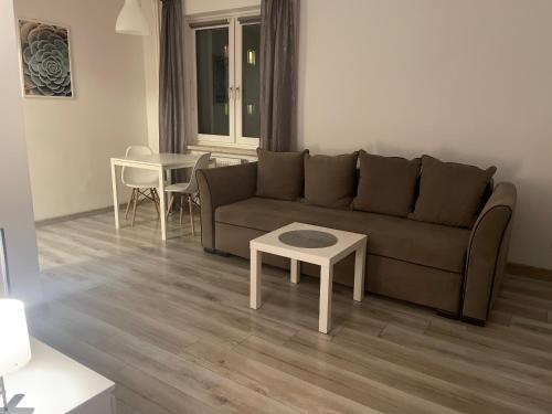 a living room with a couch and a table at Apartament Centrum in Koszalin