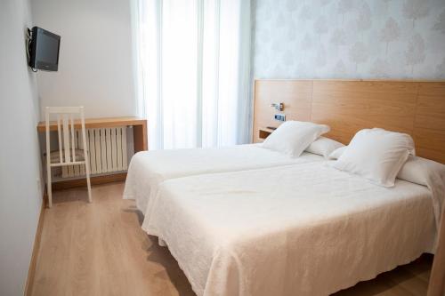 Ένα ή περισσότερα κρεβάτια σε δωμάτιο στο Hotel Casa Román