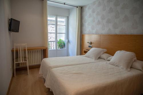Ένα ή περισσότερα κρεβάτια σε δωμάτιο στο Hotel Casa Román