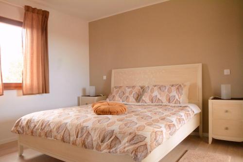 a bedroom with a bed with a pillow on it at Private Villa "San Servolo House" with sea view and private pool in Buje