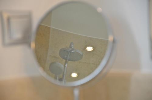 a mirror with a reflection of a room at Ino Hotel & Suites in Samos